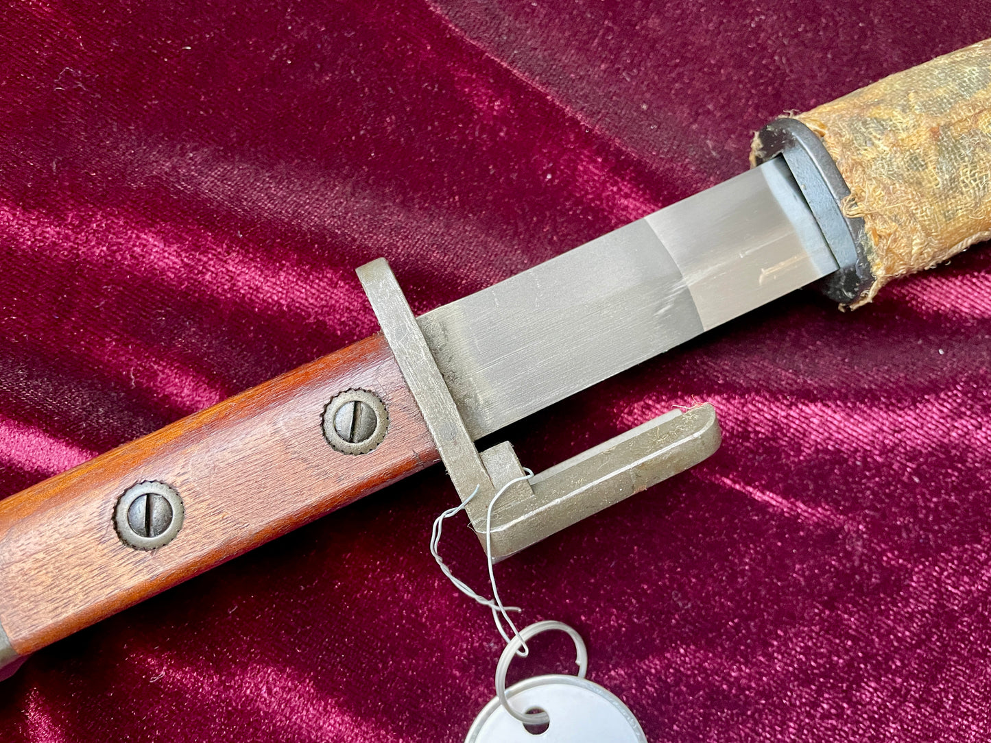Belgium FN Type A bayonet with wood grips and flash hider prongs.